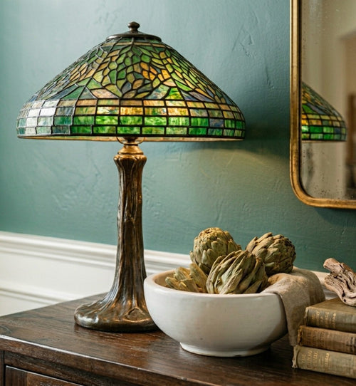 A set of three hand-preserved artichokes used as high-texture bowl fillers for a modern farmhouse table.