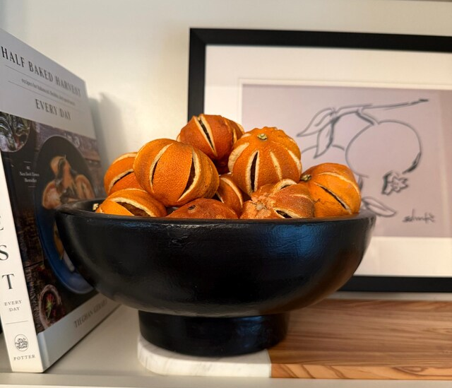 A set of whole slit dried oranges displayed in a minimalist ceramic bowl, perfect for wabi-sabi home decor and natural scenting.